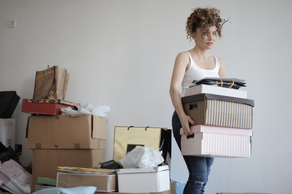 concentrated-woman-carrying-stack-of-cardboard-boxes-for-3791617 (1)